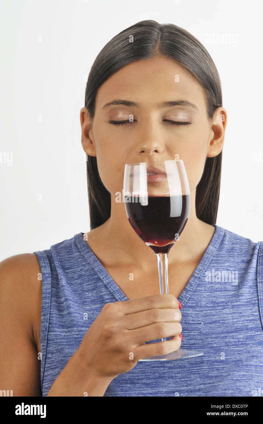 Female young adult smelling a glass of red wine Stock Photo - Alamy