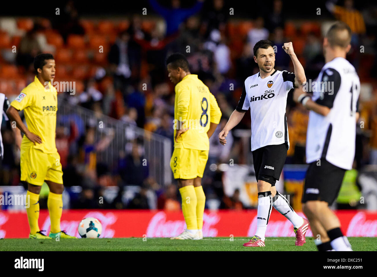 Valencia, Spain. 23rd Mar, 2014. Forward Javi Fuego of Valencia CF (2nd R) celebrates after scoring the first goal for his team during the La Liga Game between Valencia CF and Villarreal at Mestalla Stadium, Valencia © Action Plus Sports/Alamy Live News Stock Photo