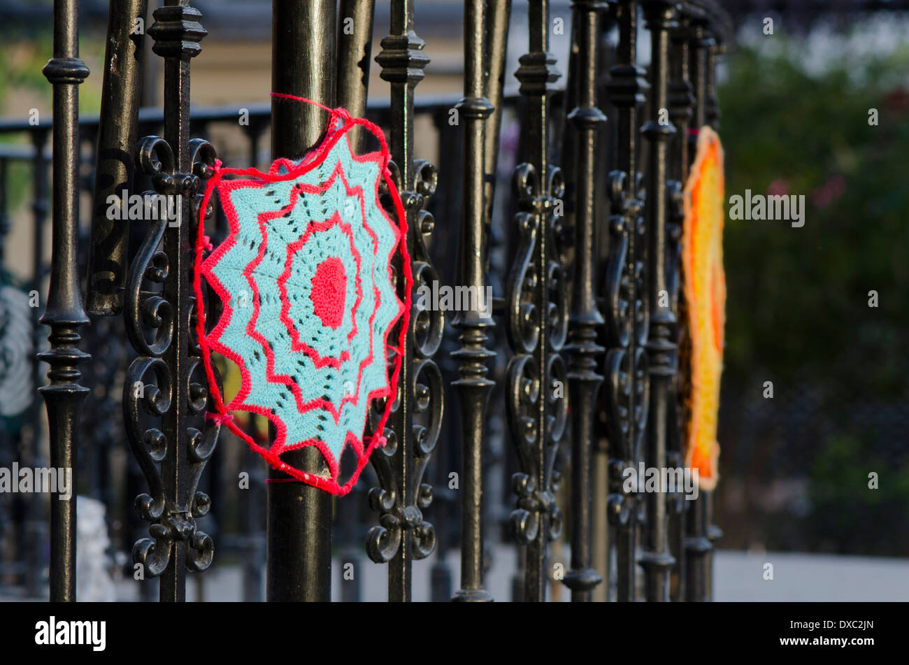 Yarn bombing, knitted circles around a public fence in Fuengirola, Spain Stock Photo