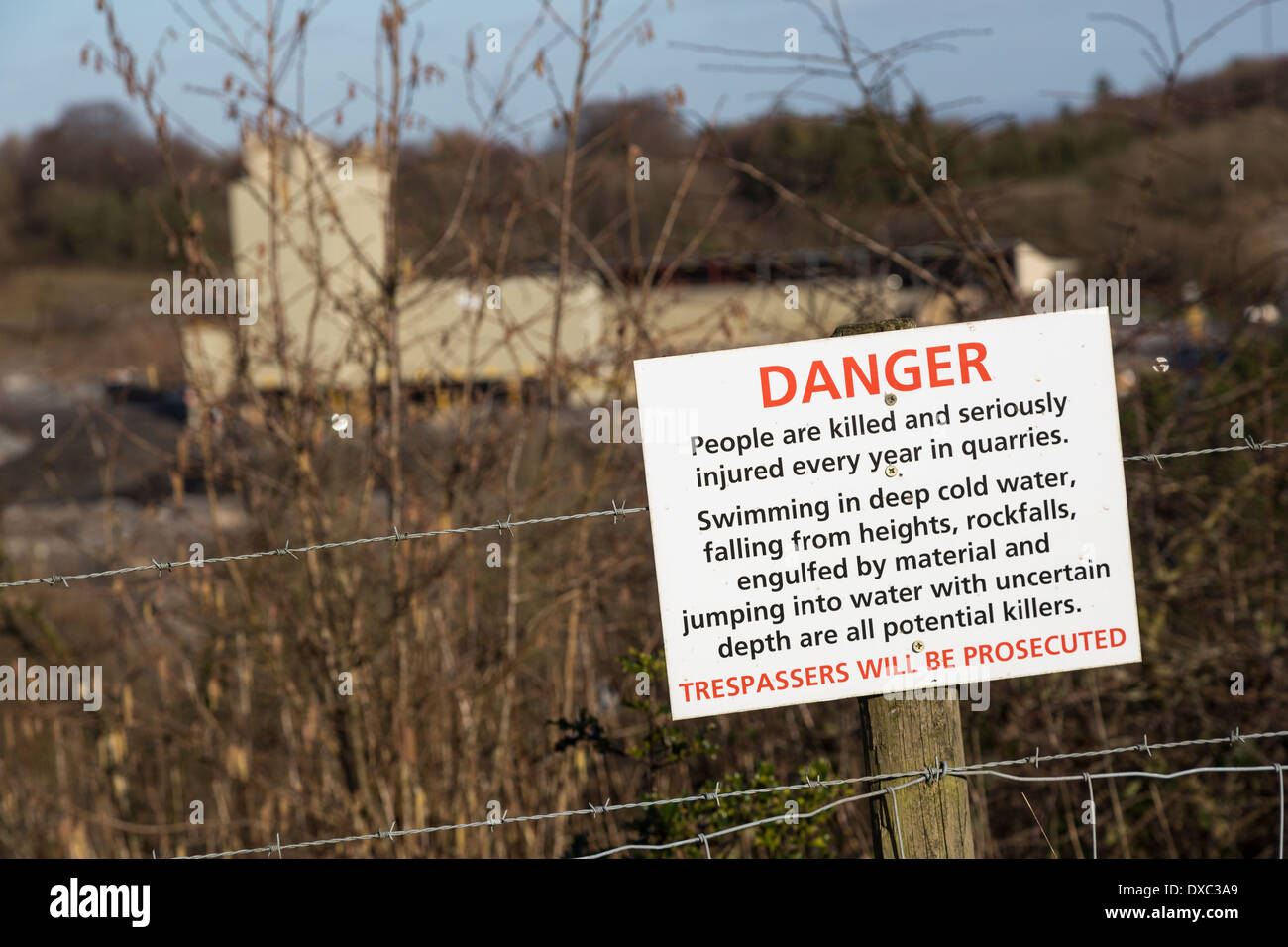 Danger sign at edge of working quarry, Lafarge Tarmac, Halecombe, Somerset, England, UK Stock Photo