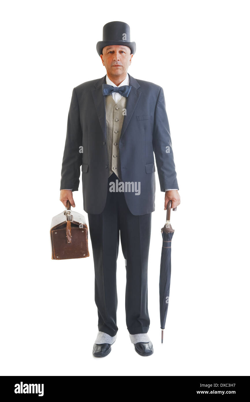 Middle aged businessman in a retro business suit with valise and umbrella isolated on white. Stock Photo