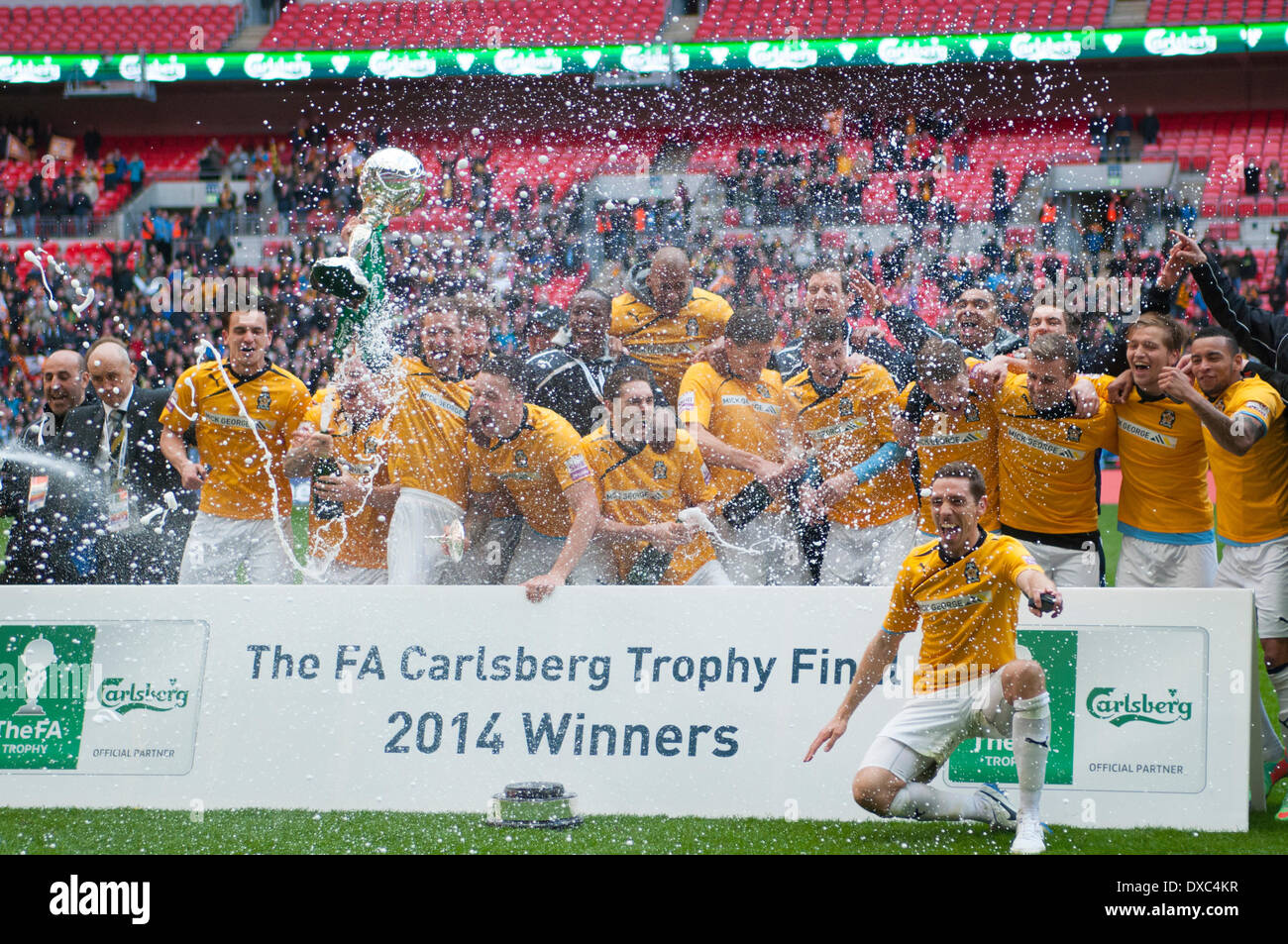 Cambridge United FC celebrate with the FA Trophy after defeating Gosport Borough FC at Wembley Stadium on the 23rd of March 2014. © Flashspix/Alamy Live News Credit:  Flashspix/Alamy Live News Stock Photo