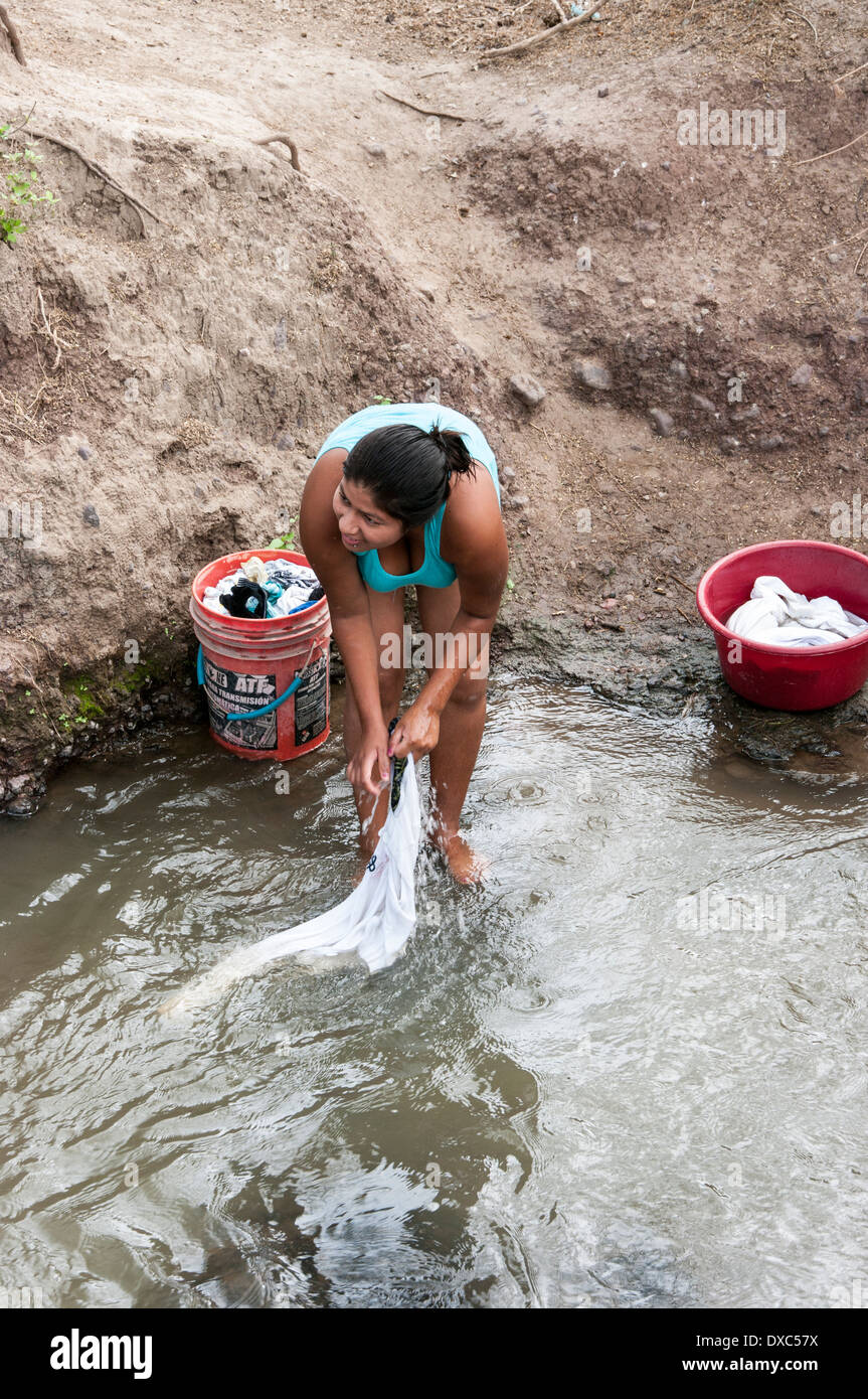 Peruvian woman washing clothes in the river.Piura, Peru. Stock Photo