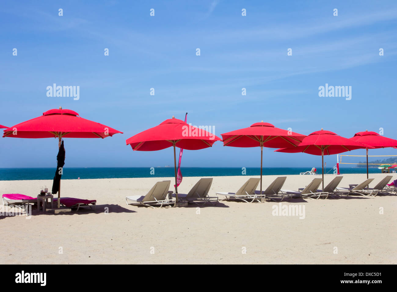 Red parasols on Bang Tao beach, Phuket, Thailand Stock Photo