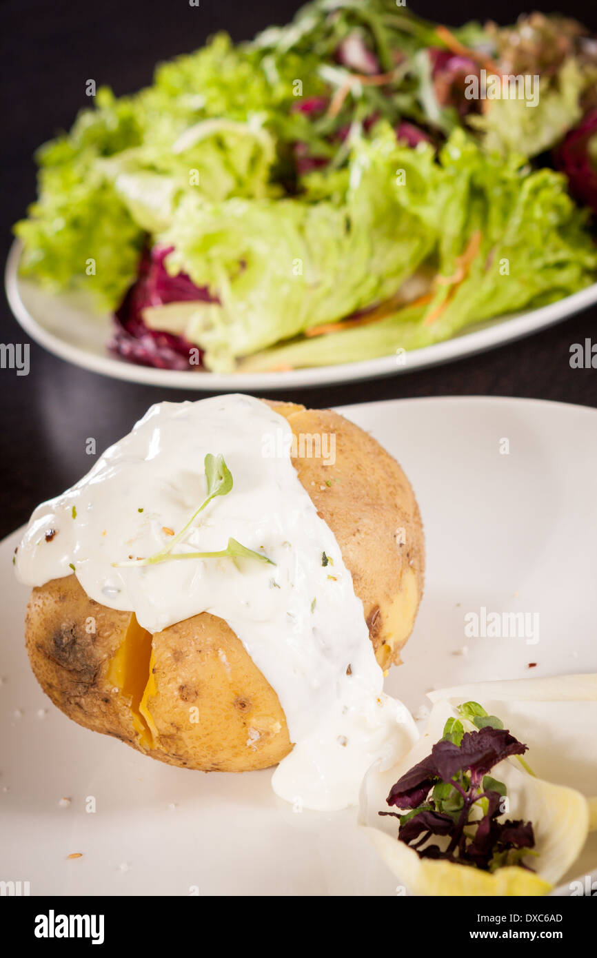 Overhead view of a healthy oven baked jacket potato with sour cream