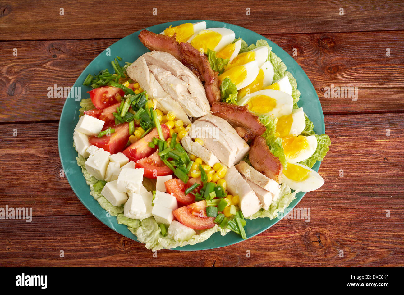 Cobb Salad - Colorful hearty entree sized salad with bacon, chicken, boiled eggs, corn, - a main-dish American garden salad  Stock Photo