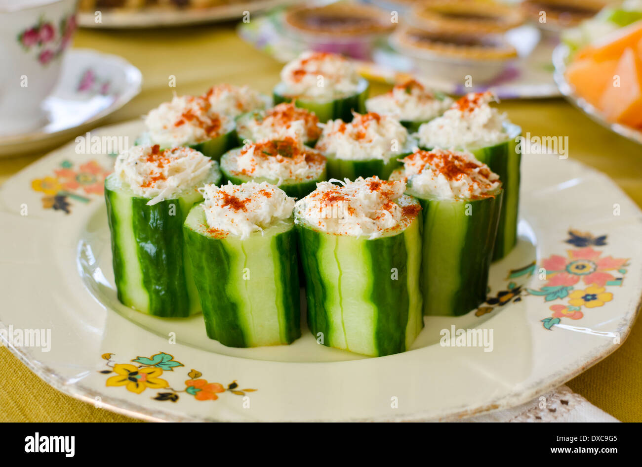 Plate of cucumber appetizers stuff with crab meat. On a table setting