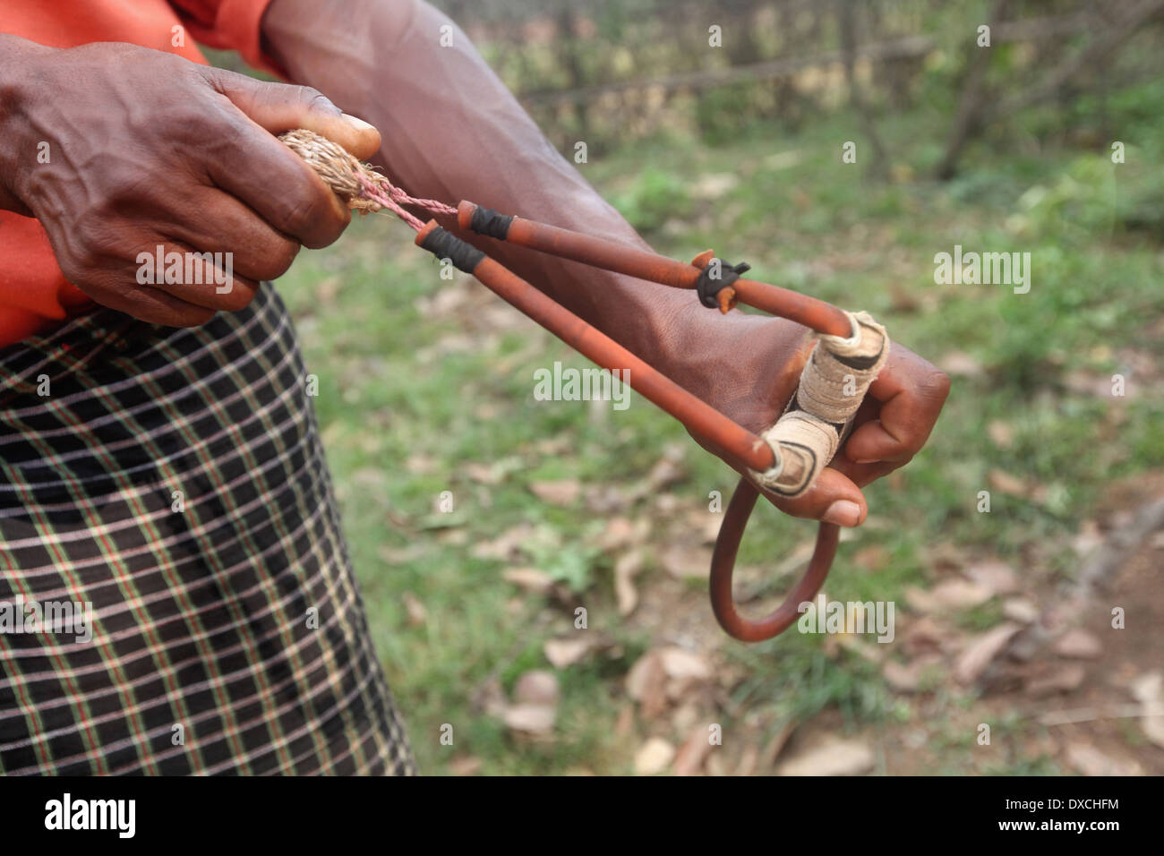 Tribal man using a Gulel (Slingshot) a hunting weapon. Santhal tribe