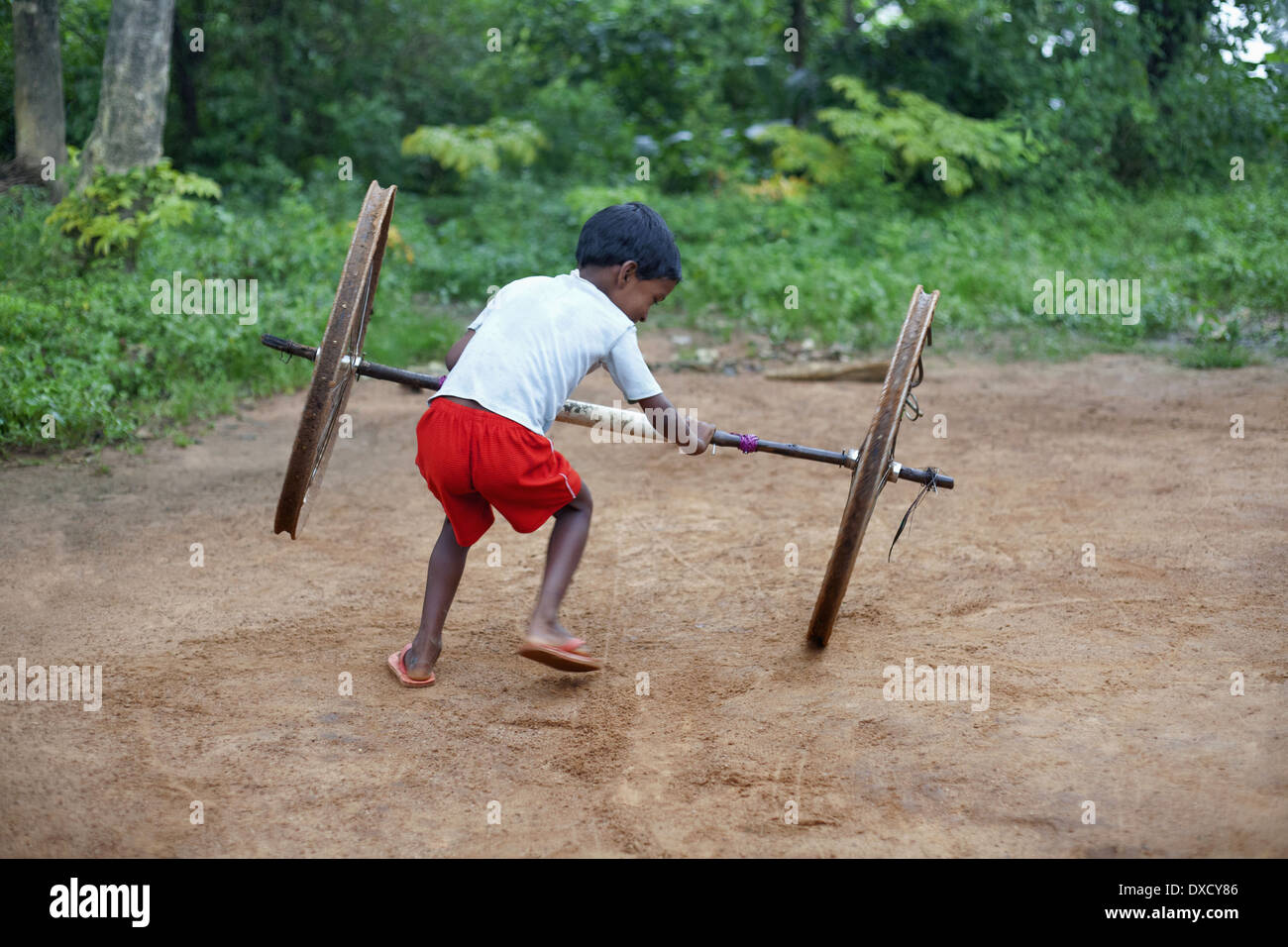 Tribal children playing with cycle wheels. Munda tribe. Bartoli village Khunti District Ranchi