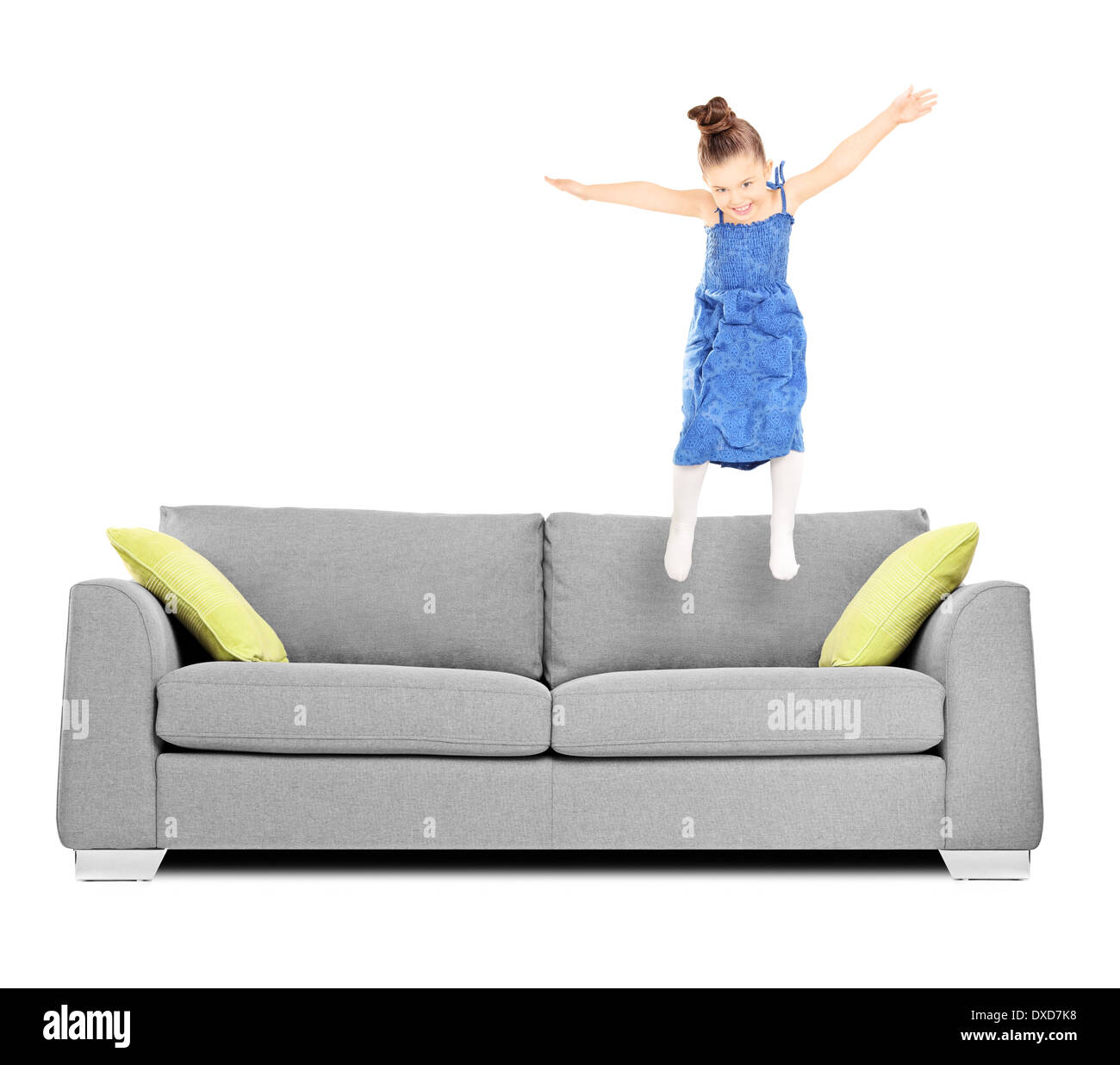 Happy female kid jumping on couch Stock Photo