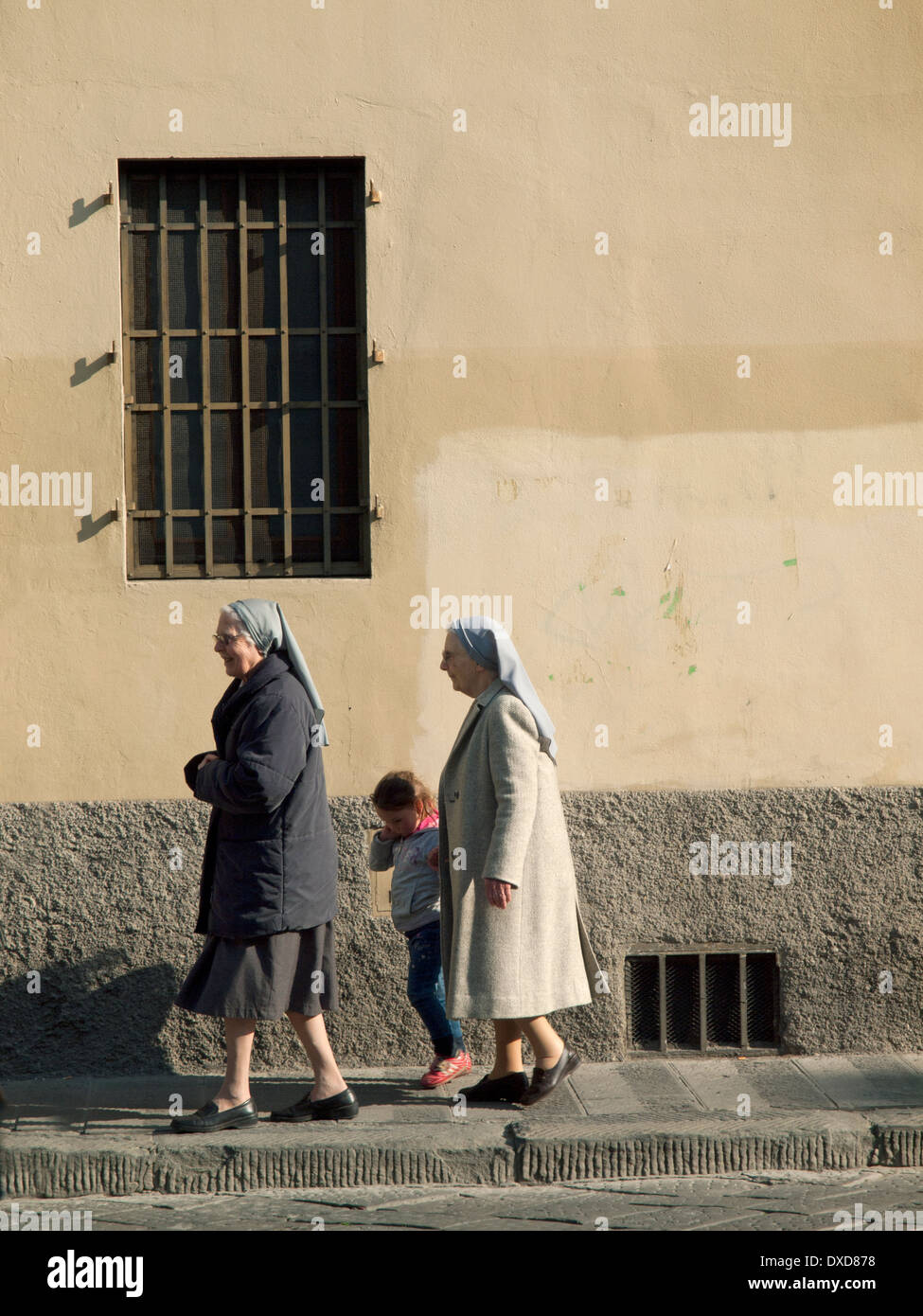 On a warm March morning in Florence two nuns go for a walk with a Stock
