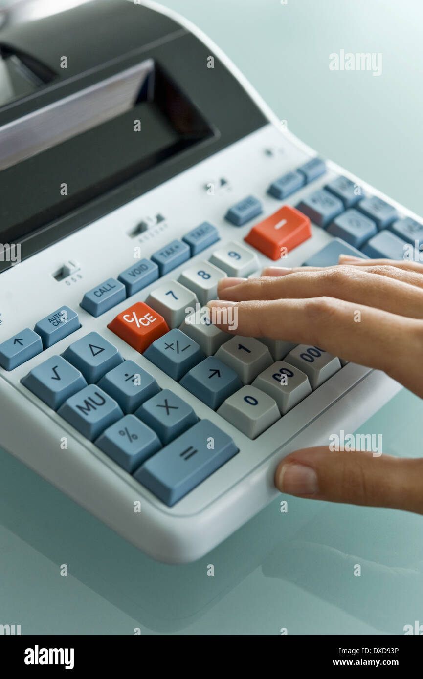 Closeup of woman's hand using calculator Stock Photo