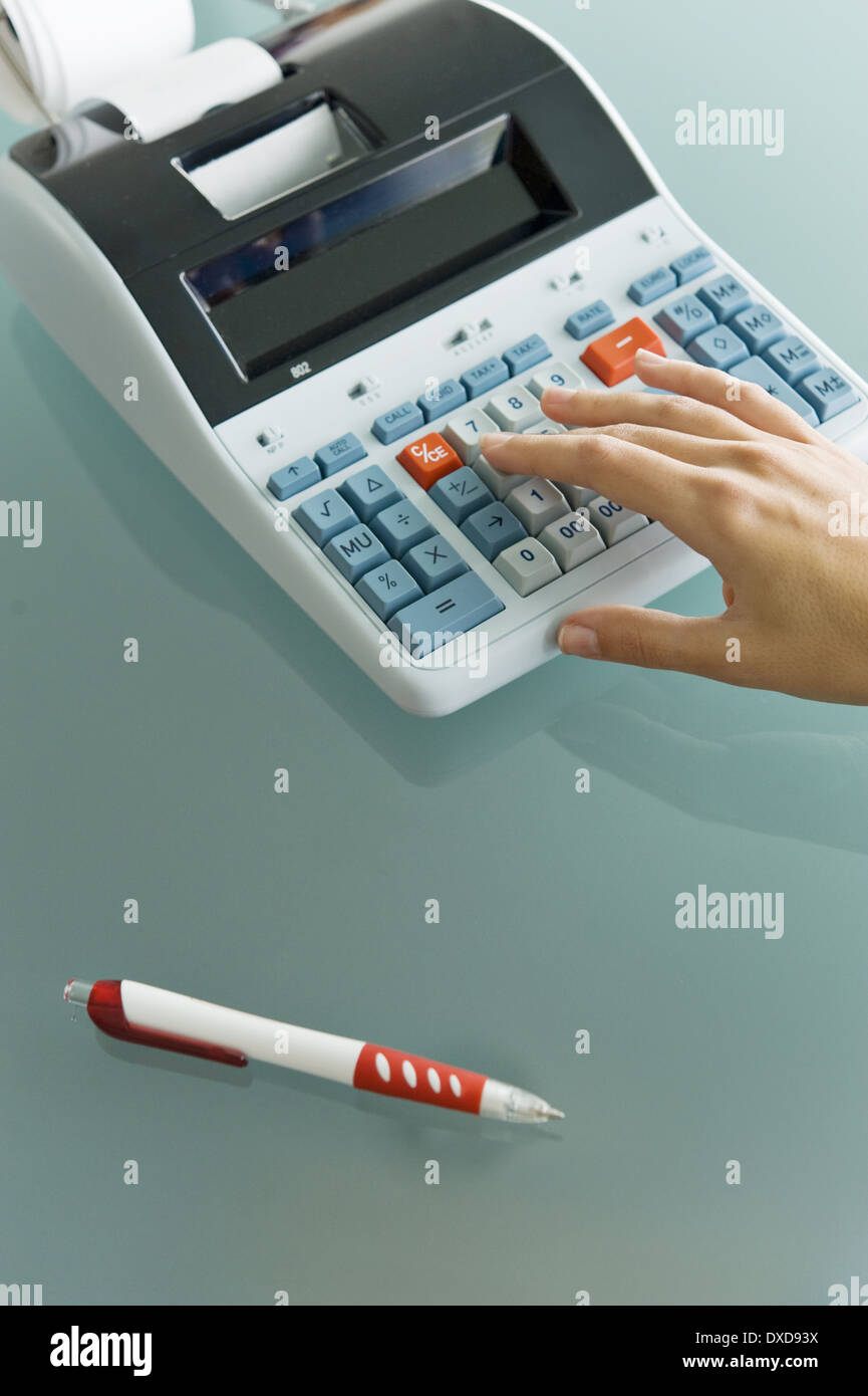 Closeup of woman's hand using calculator Stock Photo