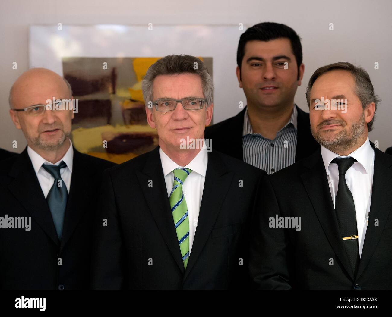 German Minister of the Interior Thomas de Maiziere (CDU, 2-L) poses with representative of the Islamic Community of Bosniaks in Germany, Bernes Alihodzic (L), Yilmaz Kahraman (2-R) of the Alevi Community of Germany and chairman of the Turkish-Islamic Institution for Religion, Bekir Alboga (R) before a consultation in Berlib, Germany, 24 March 2014. The German Minister of the Interior and representatives of Islamic organisations intend to discuss the new format of the German Islam Conference (DIK), which has existed since 2006. Photo: SOEREN STACHE/DPA Stock Photo