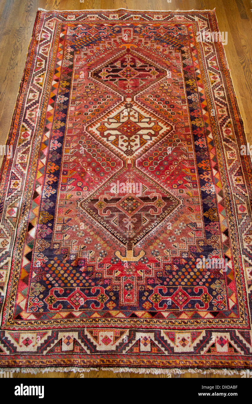 Antique hand made rug from Iran Stock Photo