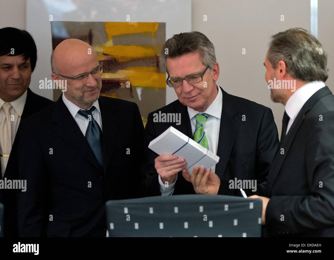 German Minister of the Interior Thomas de Maiziere (CDU, 2-R) talks to Abdelkader Rafoud (L) of the Central Council of Moroccans in Germany, representative of the Islamic Community of Bosniaks in Germany, Bernes Alihodzic (2-L) and chairman of the Turkish-Islamic Union, Bekir Alboga (R) before a consultation in Berlib, Germany, 24 March 2014. The German Minister of the Interior and representatives of Islamic organisations intend to discuss the new format of the German Islam Conference (DIK), which has existed since 2006. Photo: SOEREN STACHE/DPA Stock Photo