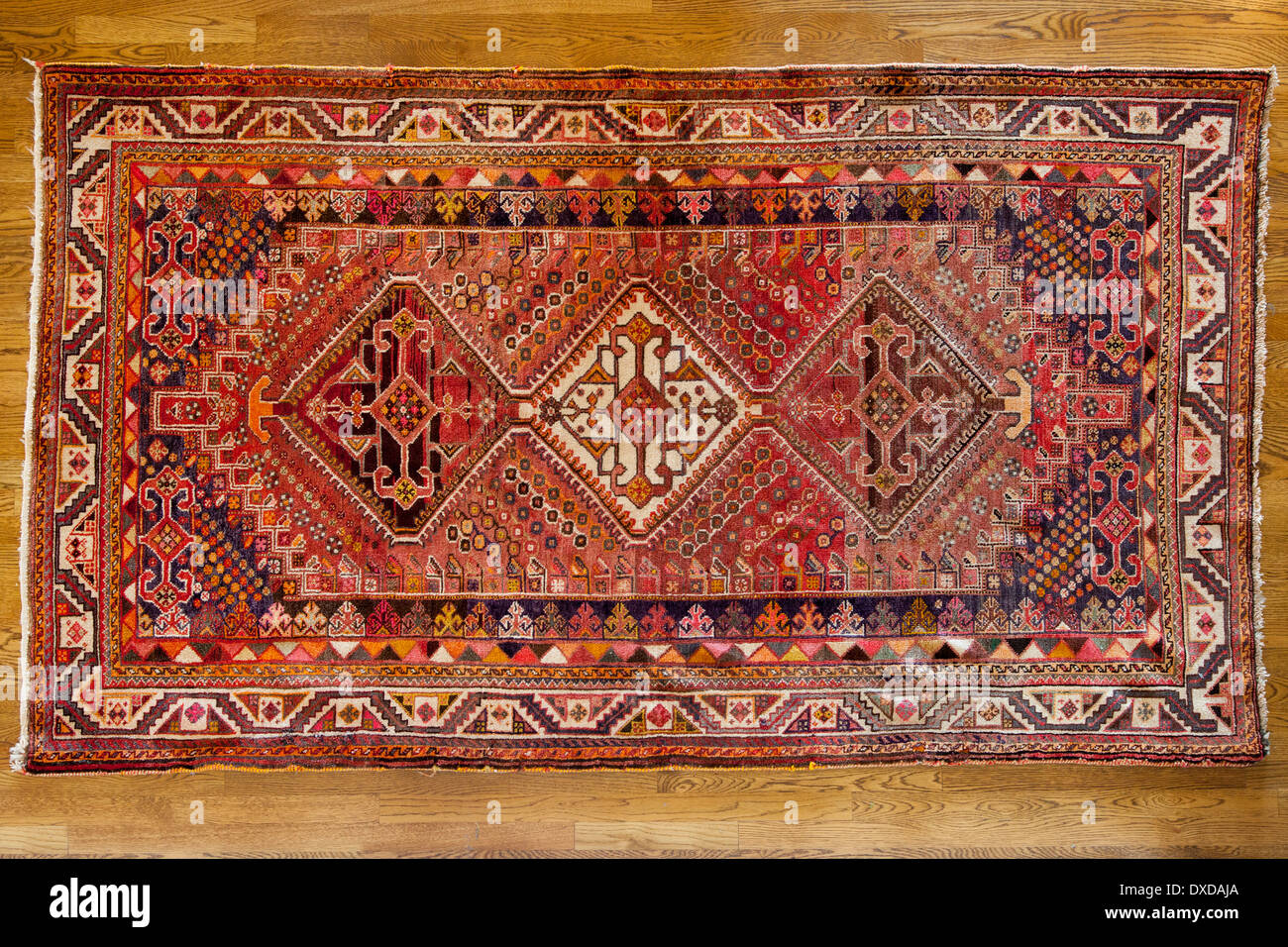 Antique hand made rug from Iran Stock Photo