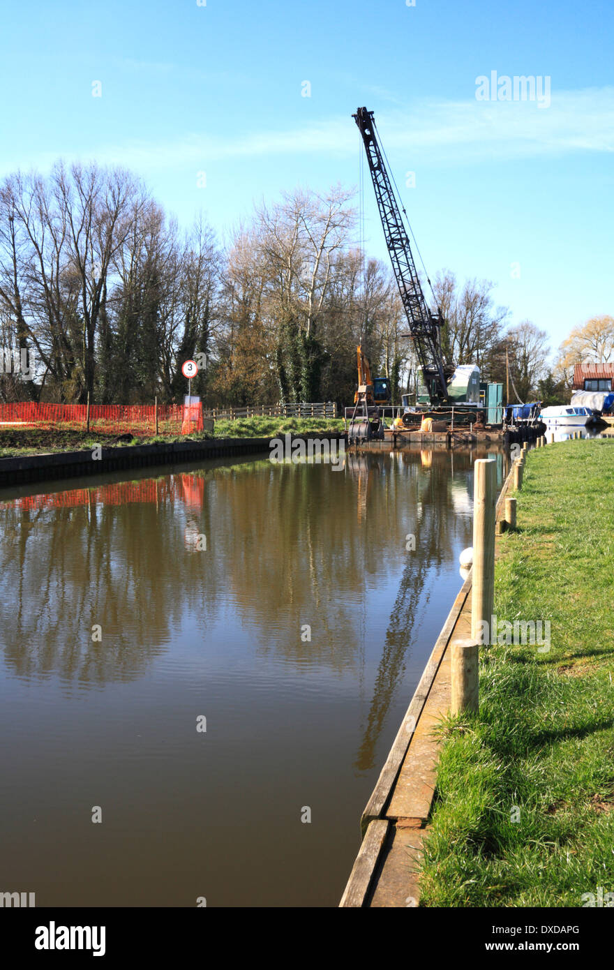 A view of Upton Dyke on the Norfolk Broads with dredging pontoon in
