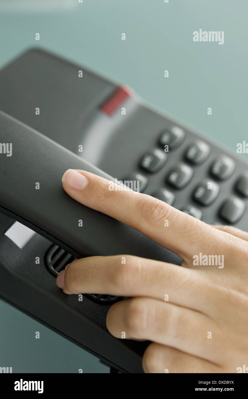 Closeup of woman's hand on telephone Stock Photo
