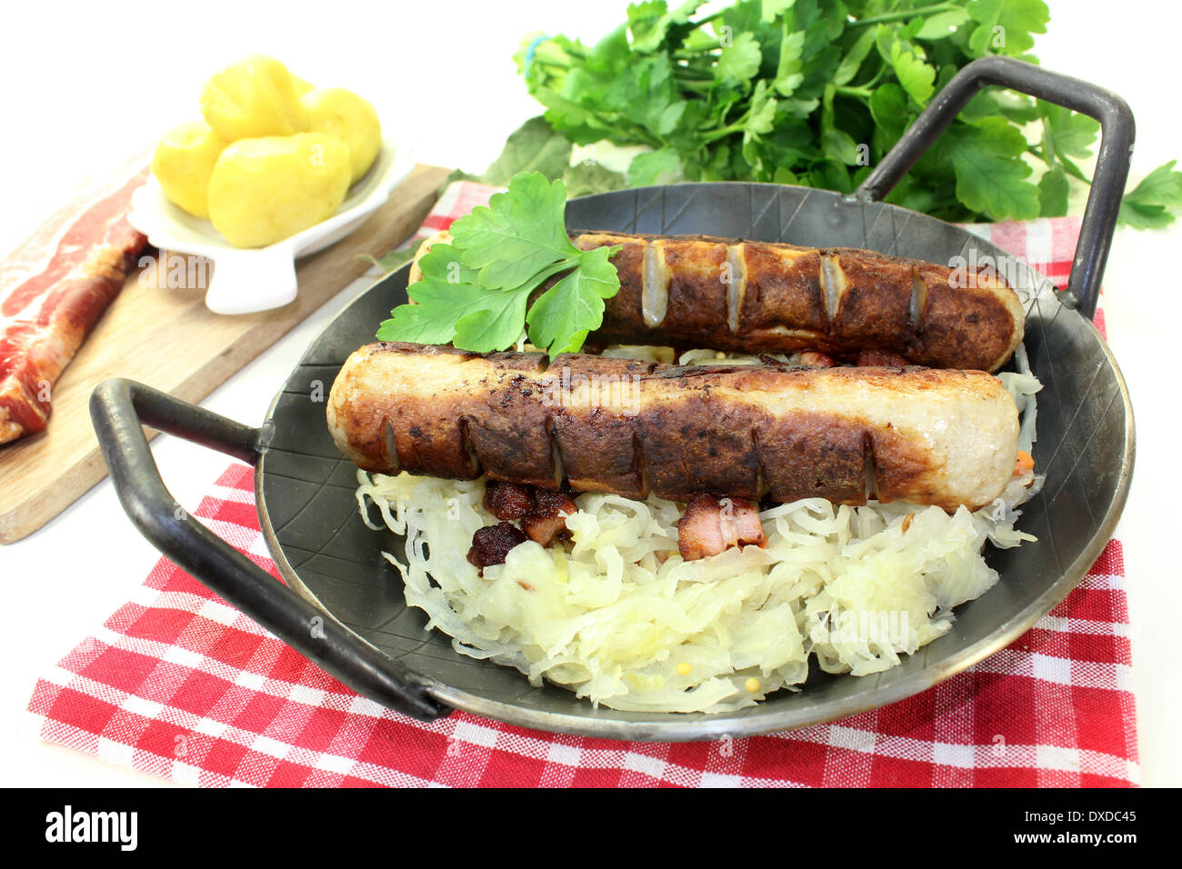 a pan with sourcrout and fried sausage Stock Photo