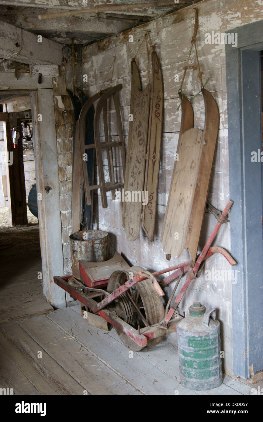 Full-length view of antique sleds hanging in a barn at the Curran Homestead, Orrington, Maine. Stock Photo
