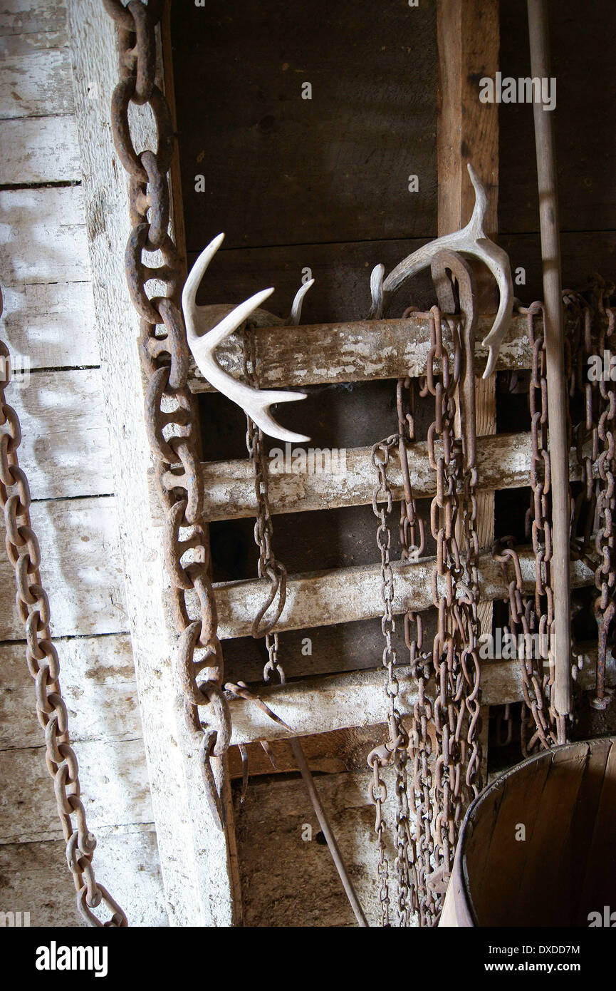 Deer antlers and antique chains in a barn at the Curran Homestead, Orrington, Maine. Stock Photo