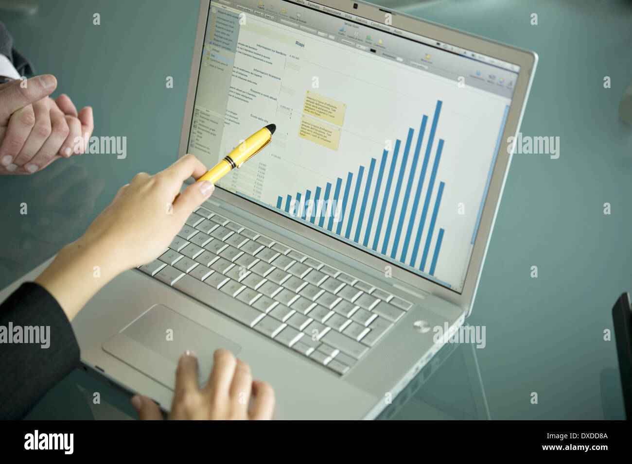 Business people's hands with laptop showing bar chart Stock Photo