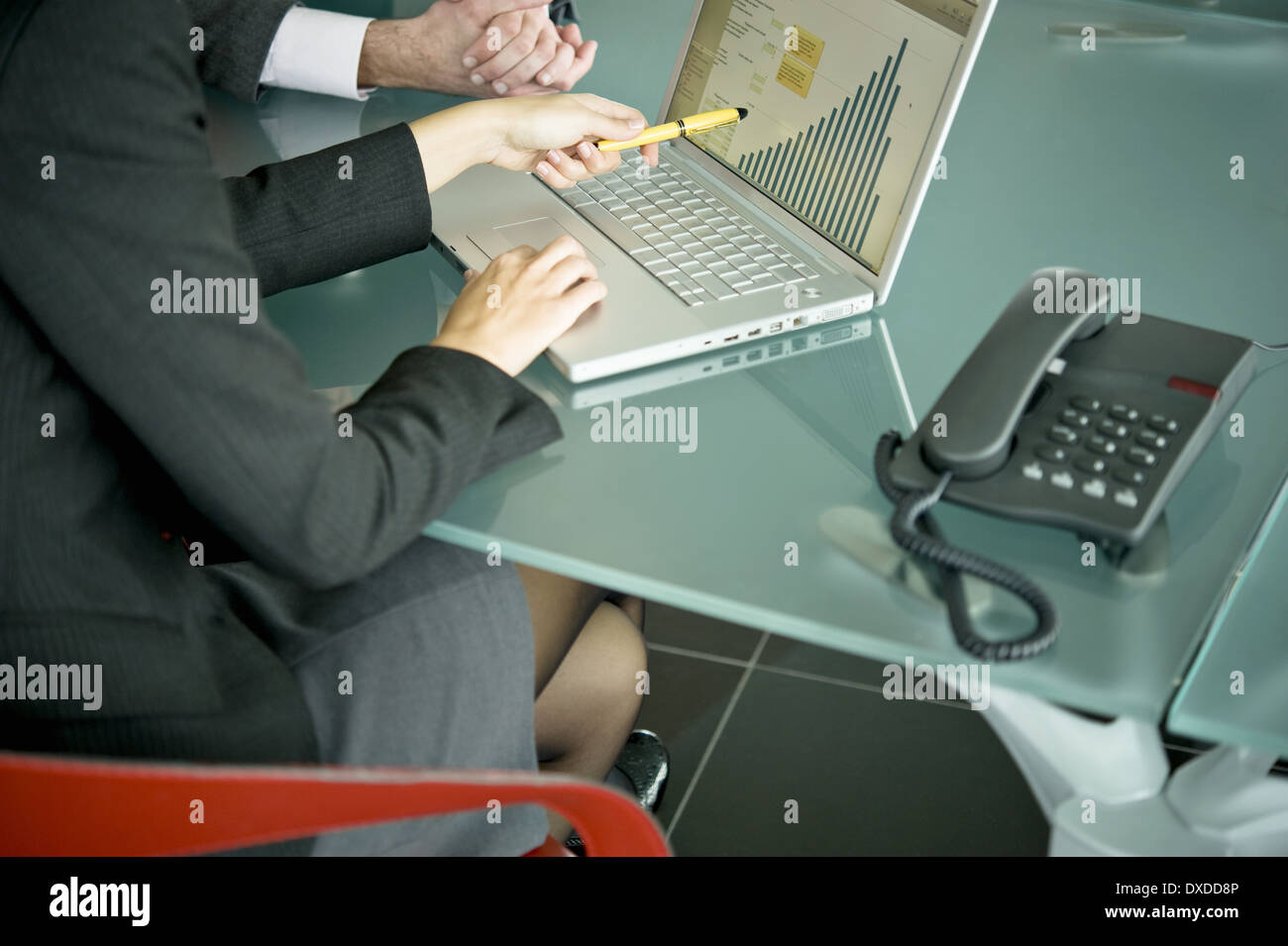 Business people with laptop showing bar chart Stock Photo