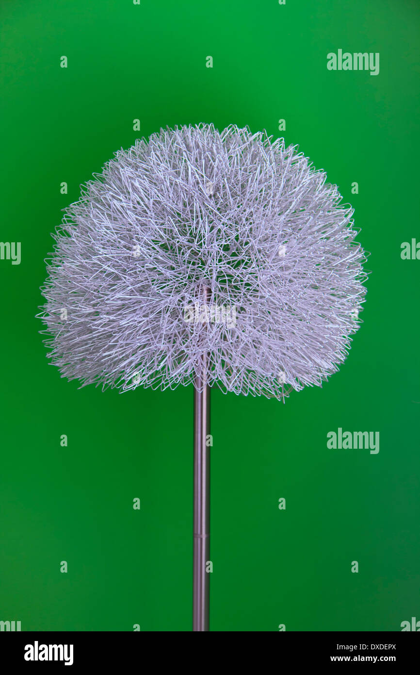 Decorative standard or floor lamp against a green wall Stock Photo