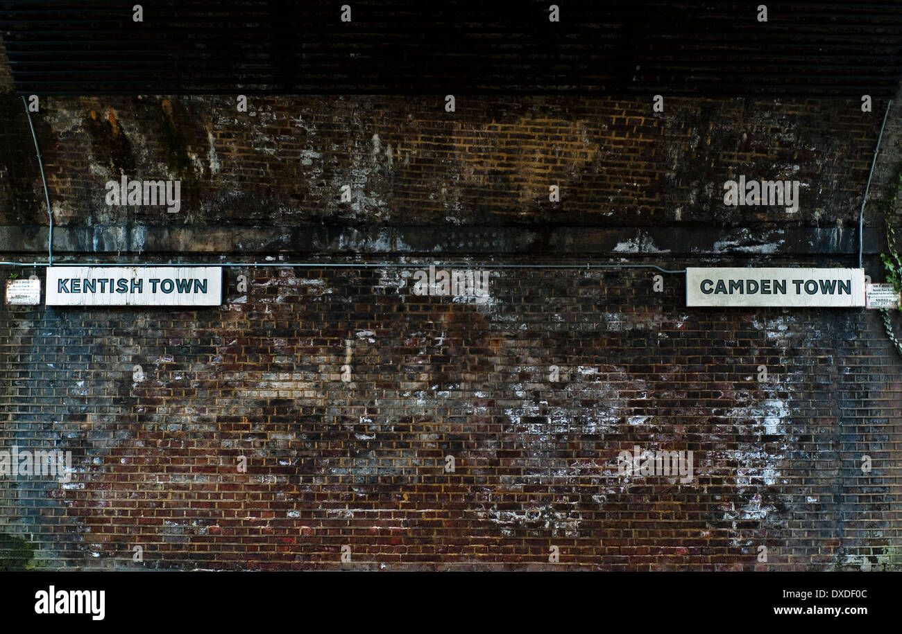 Kentish Town and Camden direction signs under Victorian railway bridge