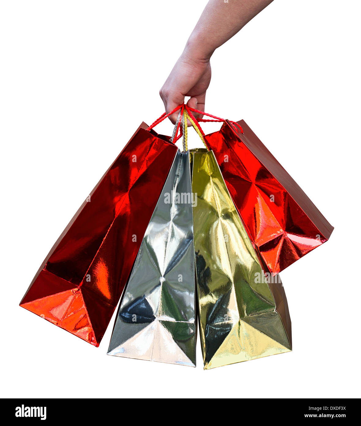 Hand carrying red and gold shiny gift bags of shopping purchased from a mall Stock Photo