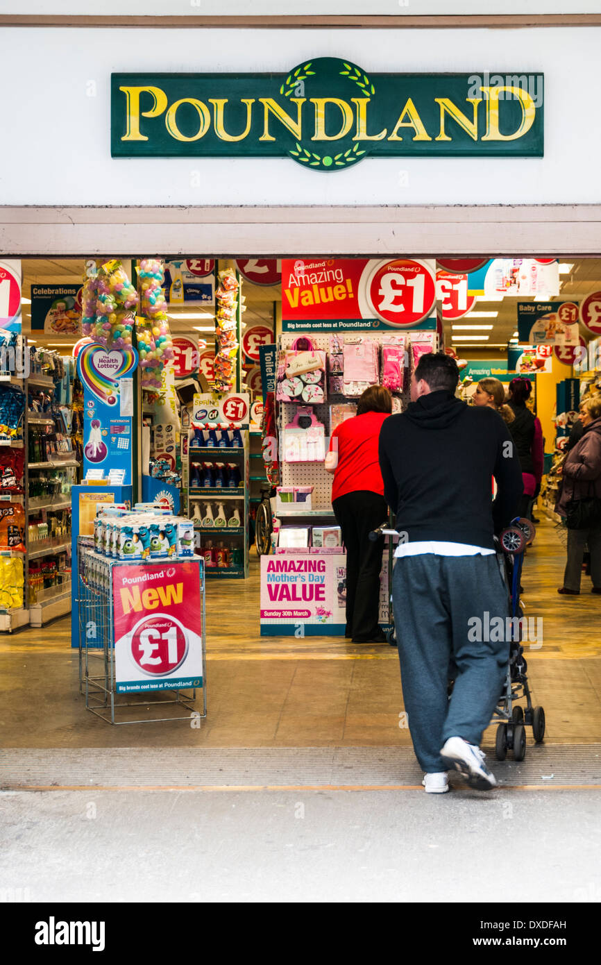 A man pushing a pushchair into the Poundland shop at Lincoln Stock Photo