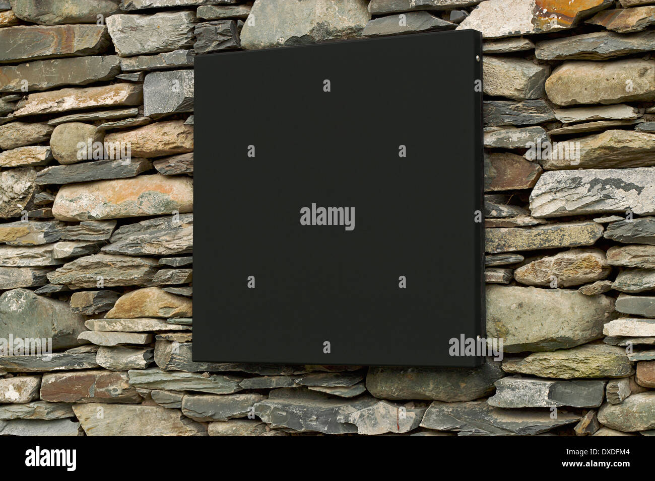 Blank contemporary sign on traditional Dry stone wall ready for insertion of your branding Stock Photo
