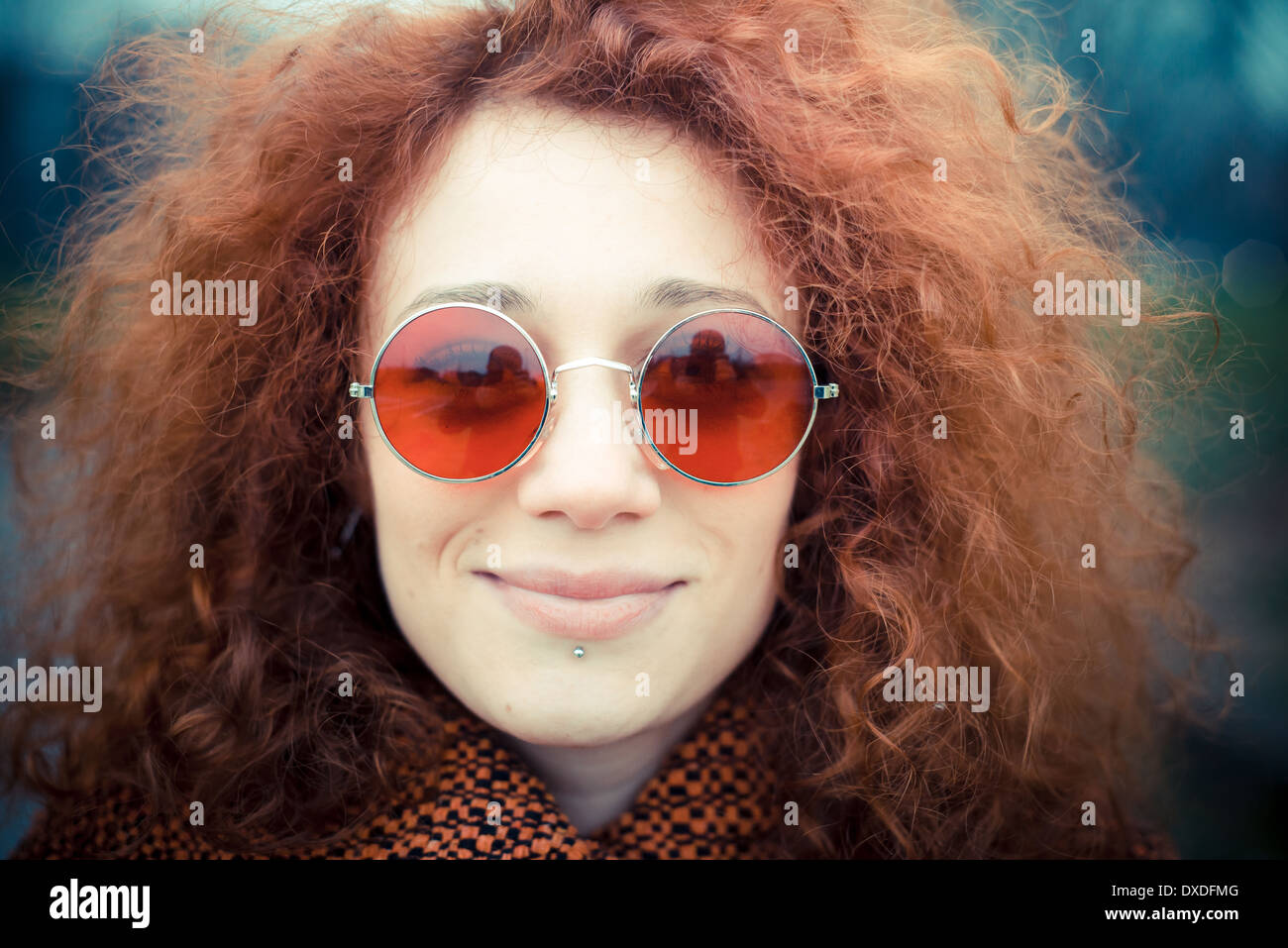 Young Beautiful Red Curly Hair Woman With Sunglasses At The Park