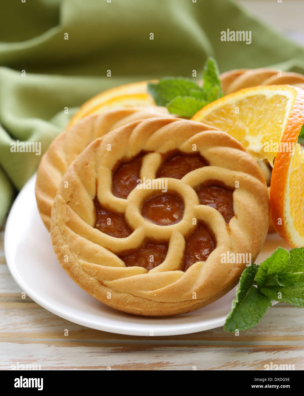 mini dessert tarts with orange on wooden table Stock Photo
