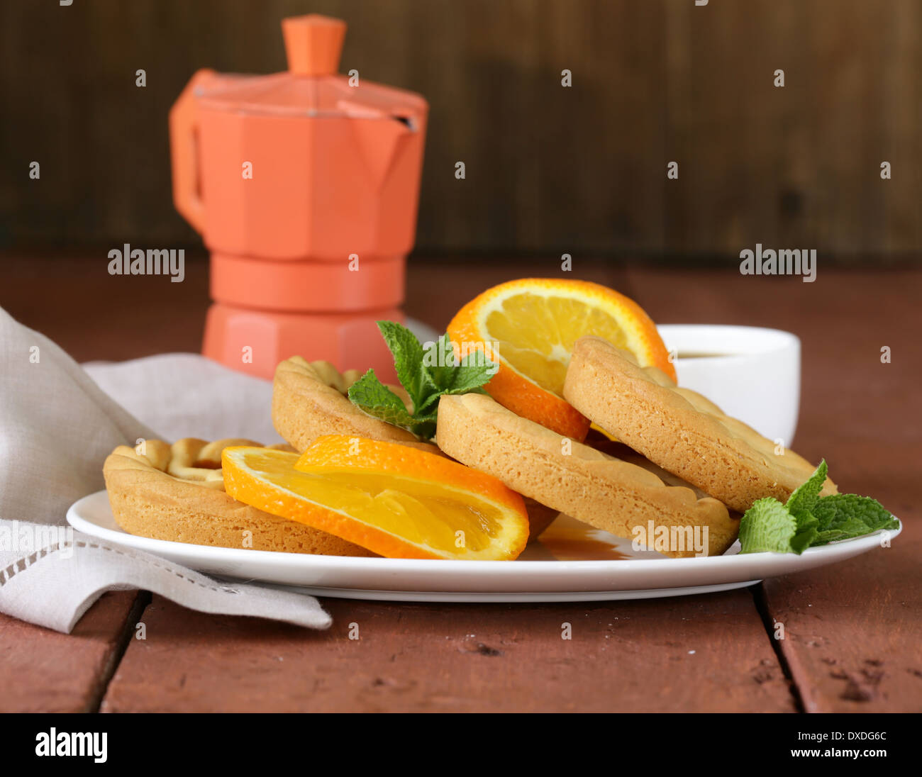 mini dessert tarts with orange on wooden table Stock Photo