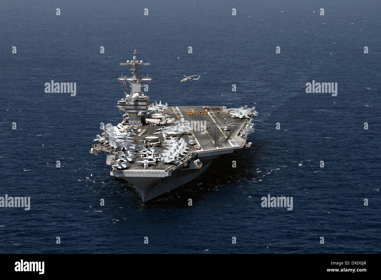 US Navy Nimitz-class nuclear aircraft carriers USS George H.W. Bush during a turnover of responsibility March 22, 2014 in the Arabian Sea. Stock Photo