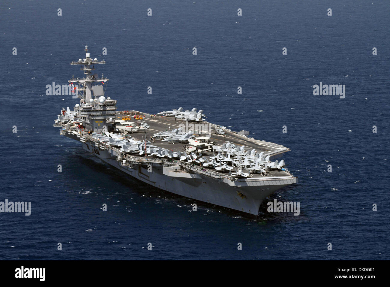 US Navy Nimitz-class nuclear aircraft carriers USS George H.W. Bush during a turnover of responsibility March 22, 2014 in the Arabian Sea. Stock Photo