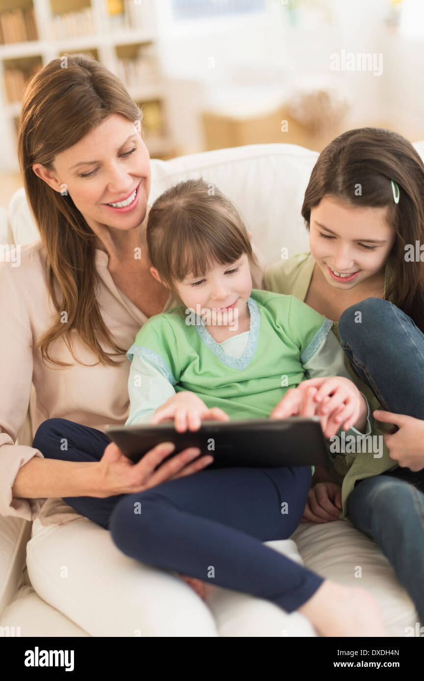Mother and daughters (4-5,8-9) using tablet pc Stock Photo
