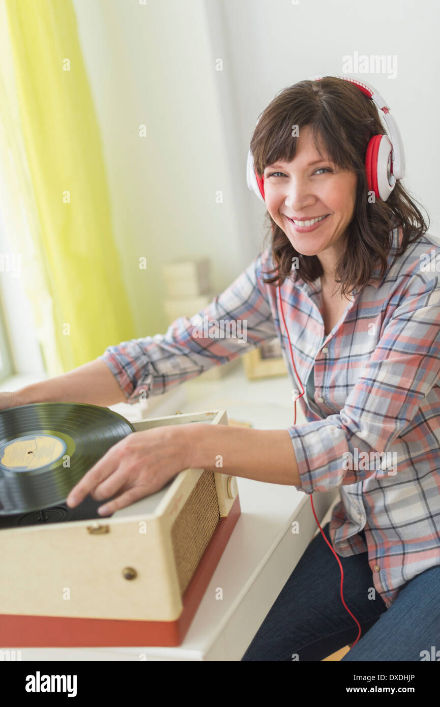 Woman listening to music on antique record player Stock Photo Alamy
