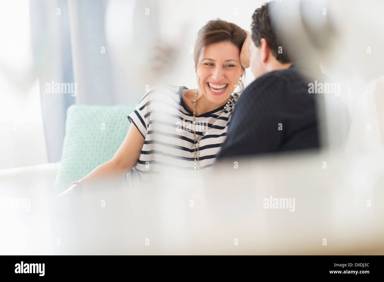 Couple sitting on sofa Stock Photo