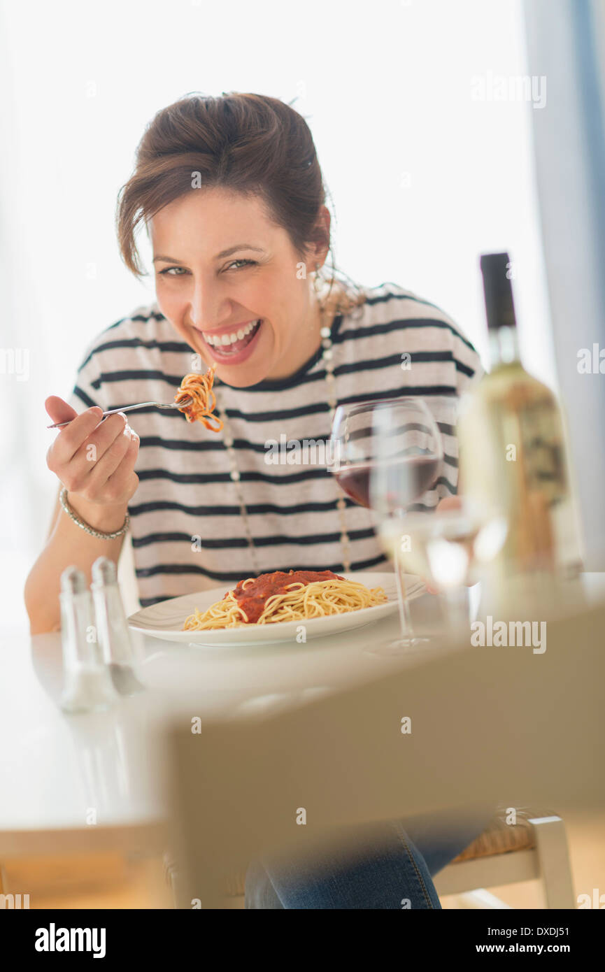 Woman eating spaghetti Stock Photo