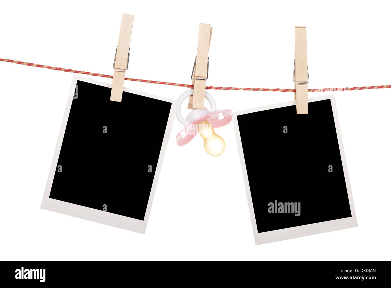 Instant photo frames and pacifier hanging on the clothesline. Isolated on white background Stock Photo
