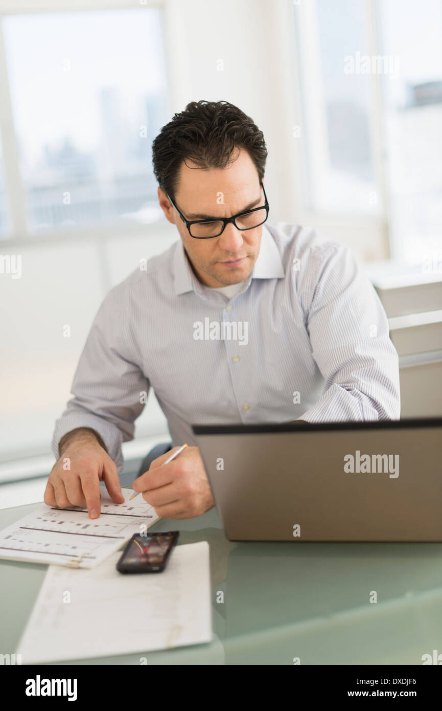 Businessman using laptop and digital tablet Stock Photo
