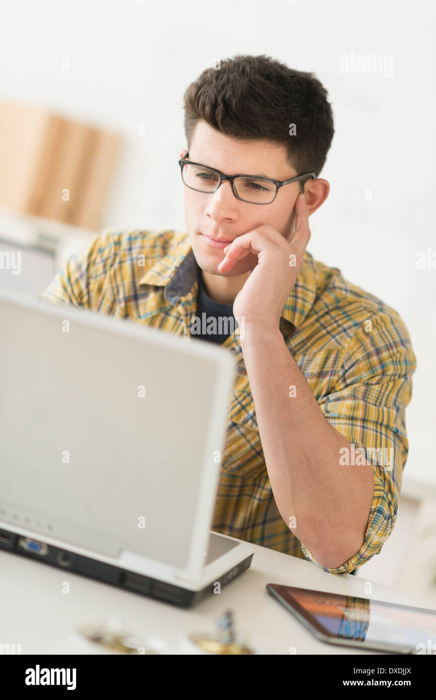 Young man using computer Stock Photo