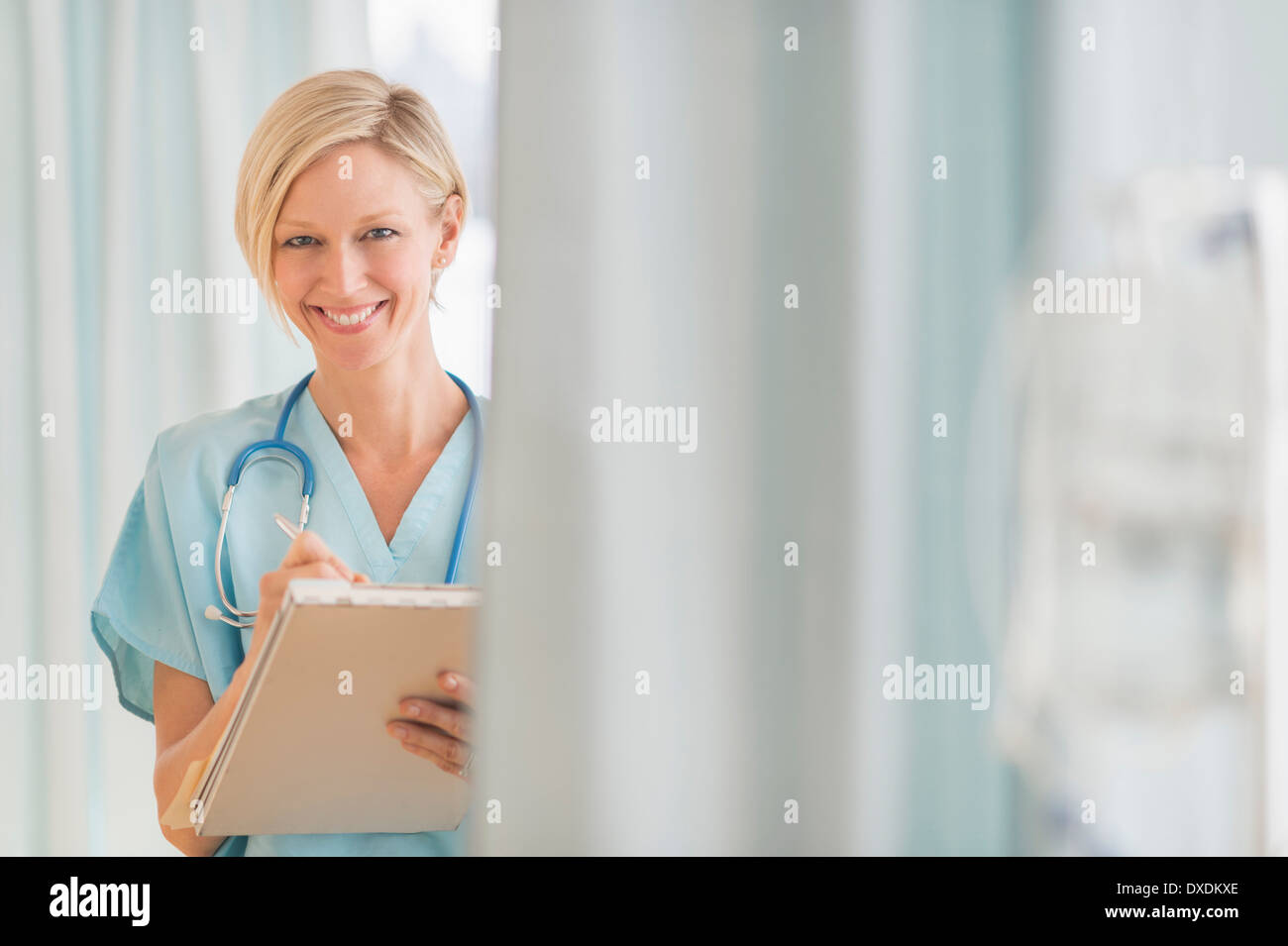 Female doctor smiling writing hospital hi-res stock photography and ...