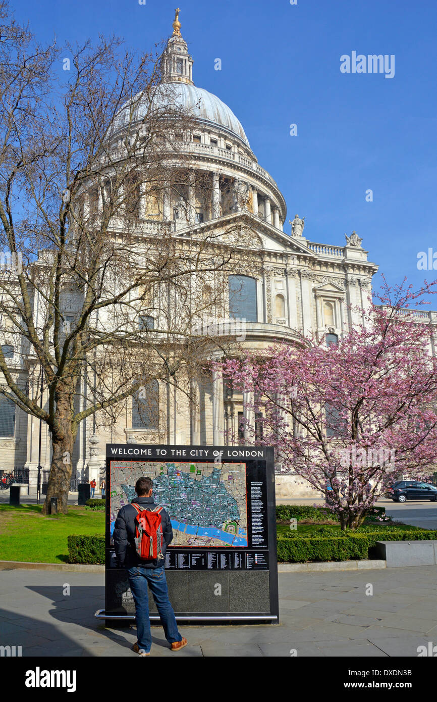 Welcome to The City of London sign and map outside St Pauls Cathedral with spring blossom beyond Stock Photo