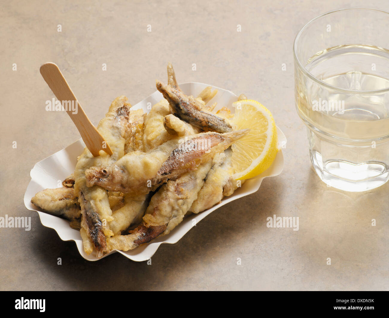 Fried Sardines with Glass of Water, Studio Shot Stock Photo