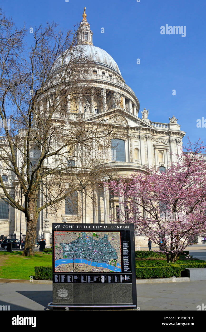 Welcome to The City of London sign and map outside St Pauls Cathedral with spring blossom beyond Stock Photo