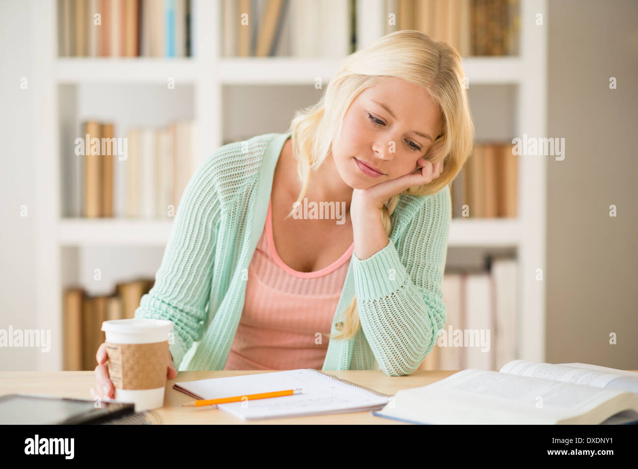 Portrait of tired female student in library Stock Photo